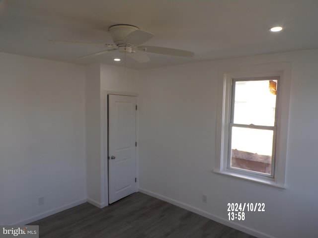 spare room with dark hardwood / wood-style floors and ceiling fan