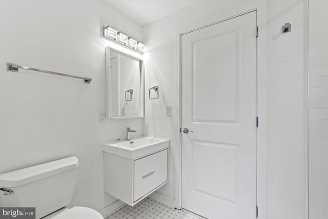bathroom featuring toilet, tile patterned floors, and vanity