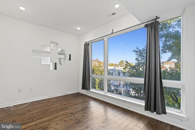 empty room with dark hardwood / wood-style floors