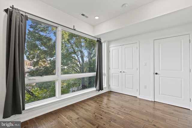 unfurnished bedroom featuring visible vents, wood finished floors, and recessed lighting