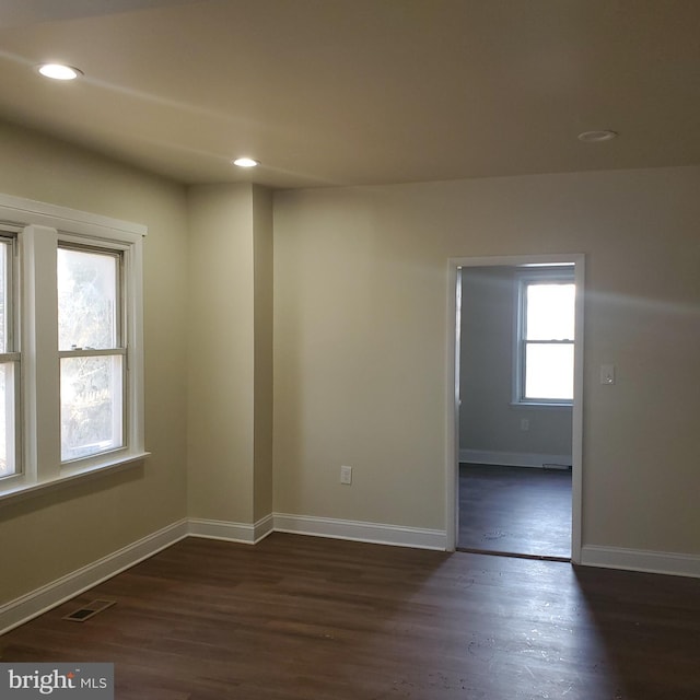 unfurnished room with dark hardwood / wood-style flooring