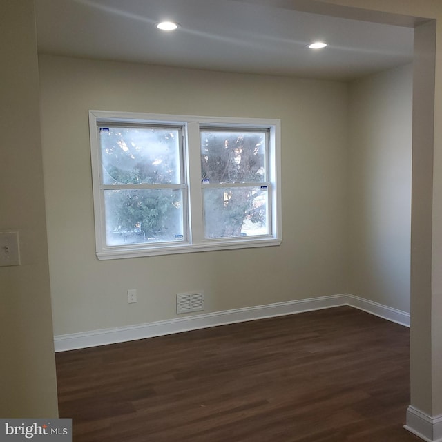 spare room featuring dark hardwood / wood-style floors