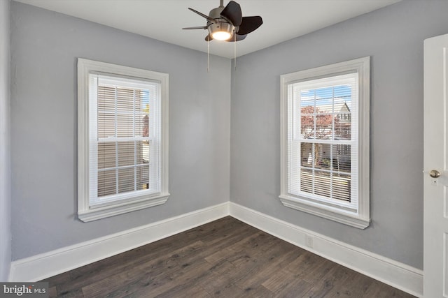 spare room featuring dark wood-type flooring and ceiling fan