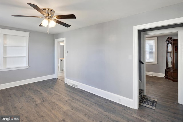 spare room with dark wood-type flooring and ceiling fan