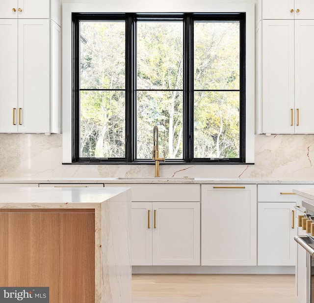 kitchen featuring white cabinets, sink, and plenty of natural light