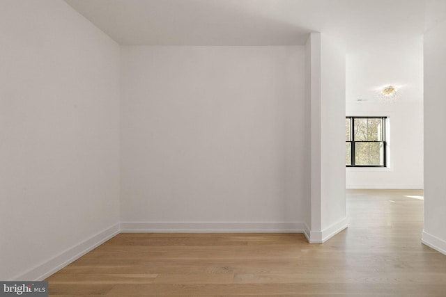 empty room with light hardwood / wood-style flooring