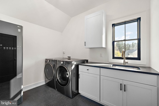 laundry room featuring sink, washing machine and dryer, and cabinets