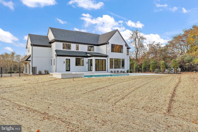 back of property with a patio