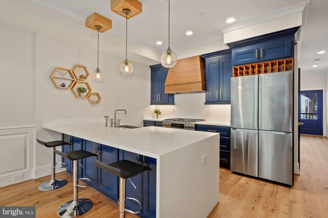 kitchen featuring light hardwood / wood-style floors, sink, stainless steel appliances, and blue cabinets