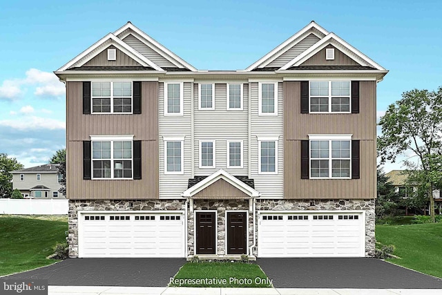 view of front facade featuring a front yard and a garage