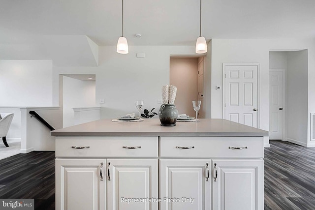 kitchen with white cabinetry, hanging light fixtures, and dark hardwood / wood-style flooring