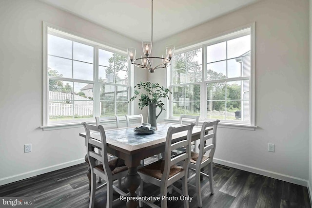 dining room featuring dark hardwood / wood-style flooring, a chandelier, and plenty of natural light