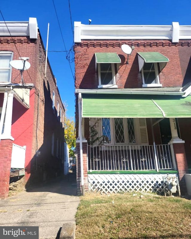 313 Pennell St, Chester, PA 19013 - view of front of home featuring covered porch and brick siding