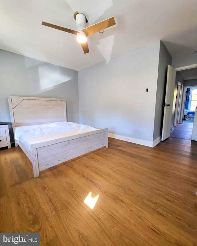 unfurnished bedroom featuring hardwood / wood-style flooring and ceiling fan