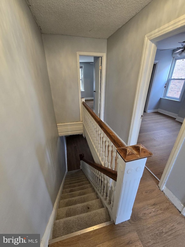 313 Pennell St, Chester, PA 19013 - stairs featuring baseboards, wood finished floors, and a textured ceiling