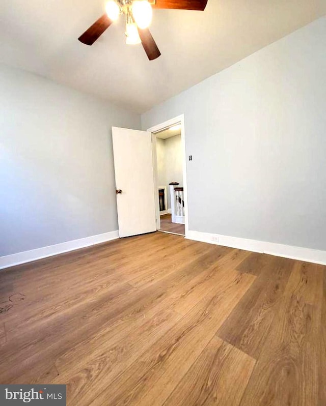 empty room with hardwood / wood-style flooring and ceiling fan