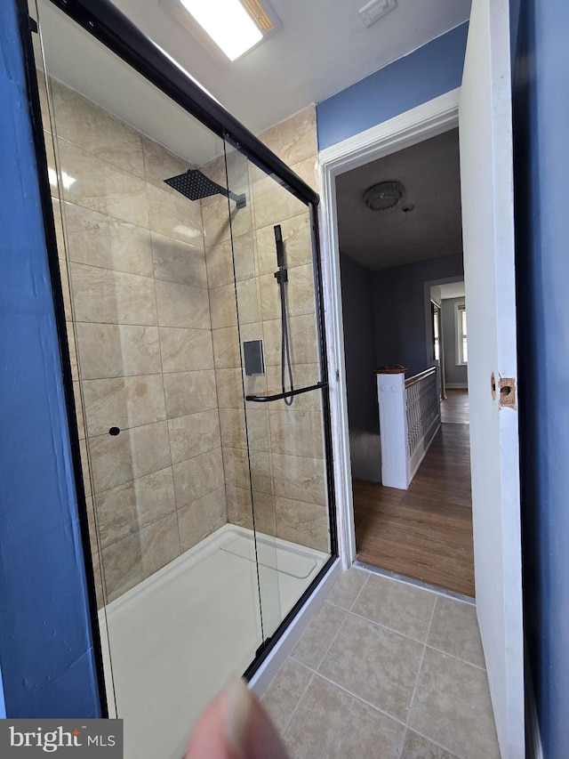 bathroom with tile patterned flooring and an enclosed shower