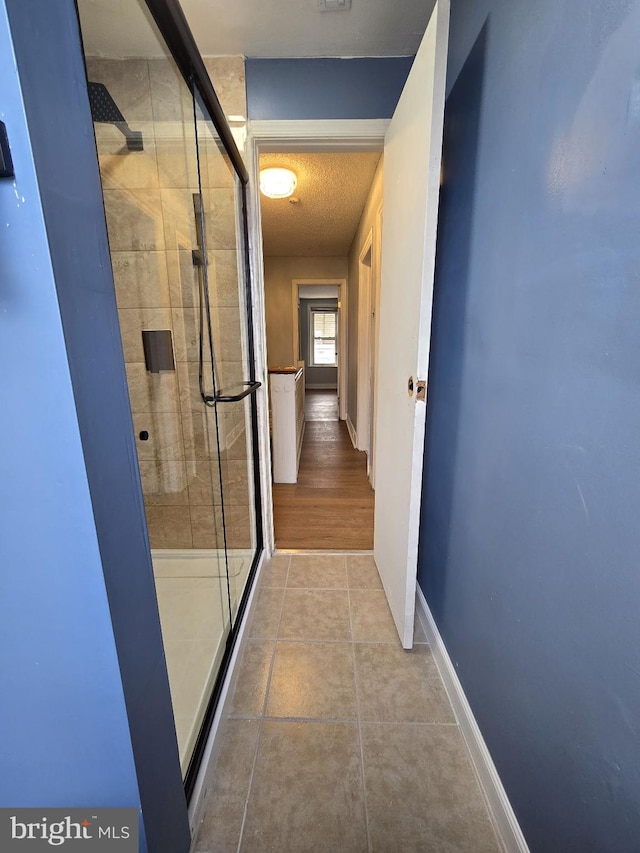 interior space featuring tile patterned flooring and an enclosed shower