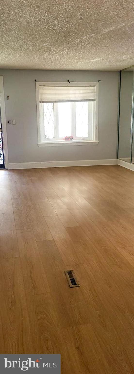 313 Pennell St, Chester, PA 19013 - spare room featuring baseboards, visible vents, wood finished floors, and a textured ceiling