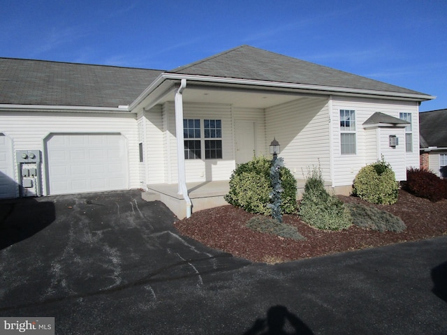 view of front of property with covered porch and a garage