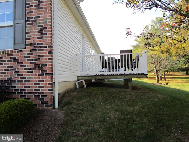 view of home's exterior featuring a lawn and a wooden deck