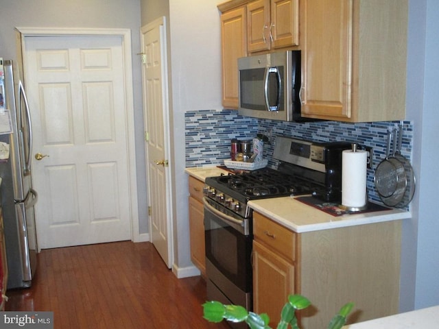 kitchen featuring backsplash, stainless steel appliances, and dark wood-type flooring