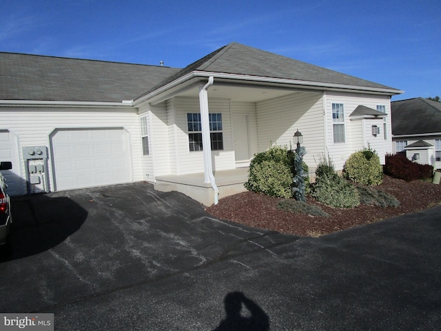 view of front facade with a porch and a garage