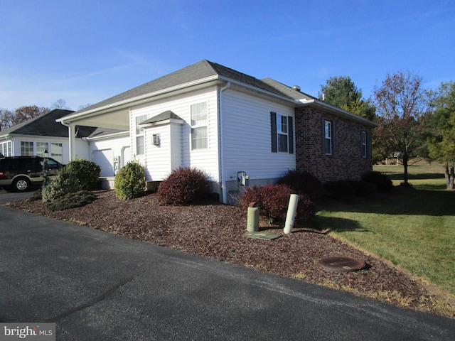 view of home's exterior with a yard