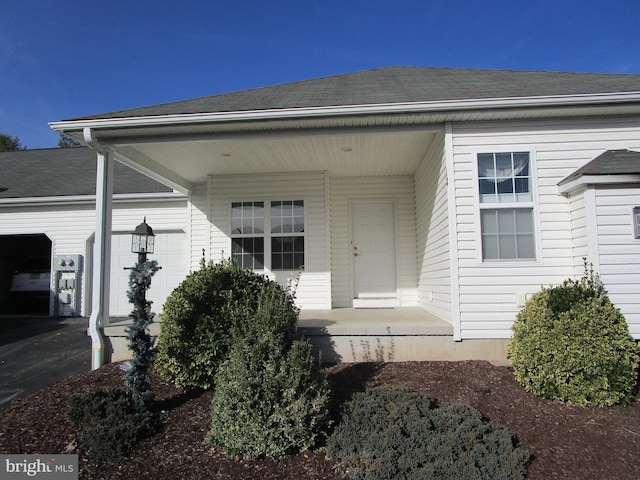 doorway to property with a garage