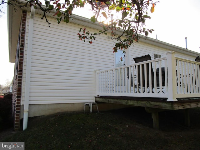 view of home's exterior with a wooden deck