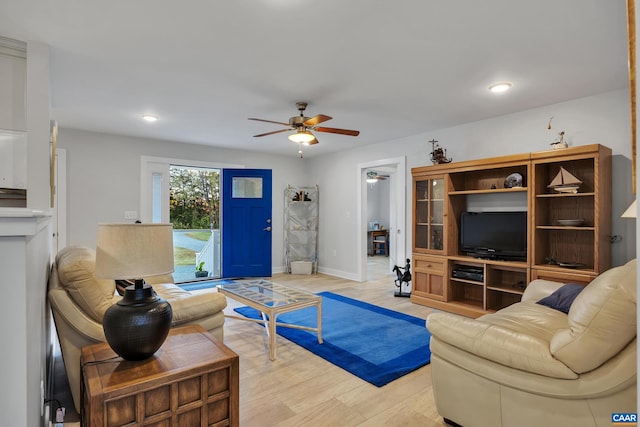 living room with light wood-type flooring and ceiling fan