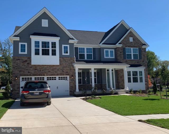 view of front of home featuring a garage and a front lawn