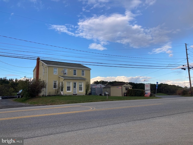 view of front facade with a chimney