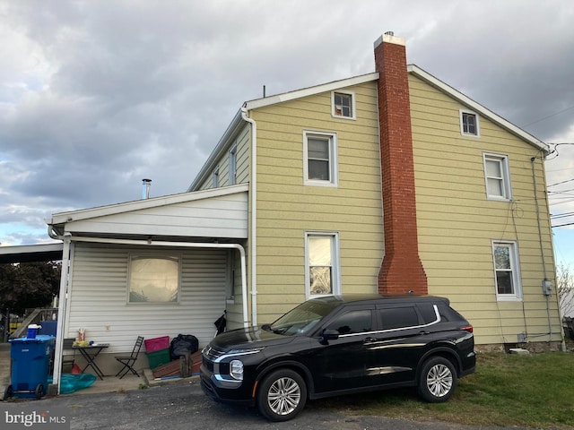 back of property featuring a chimney