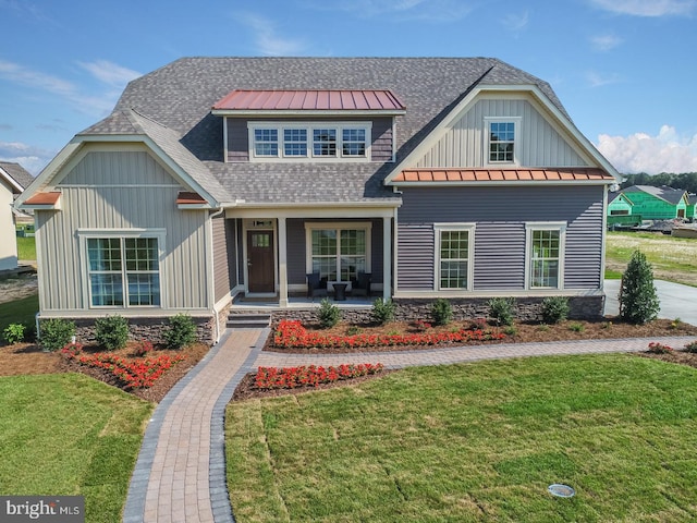 craftsman house featuring a front yard and covered porch