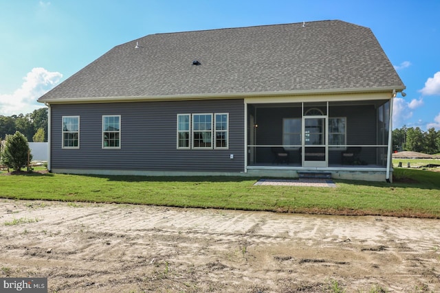 back of house with a lawn and a sunroom