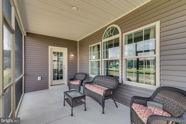 sunroom featuring wood ceiling