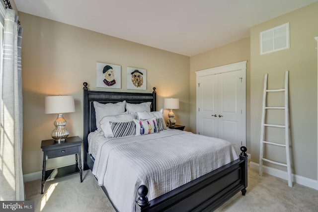 bedroom featuring a closet and light colored carpet