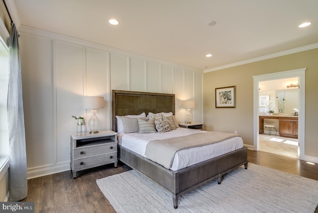 bedroom featuring crown molding, ensuite bathroom, and wood-type flooring