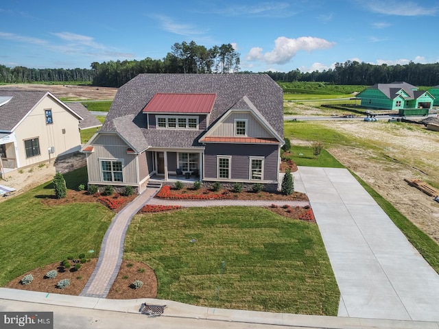 view of front of property featuring a front yard and covered porch