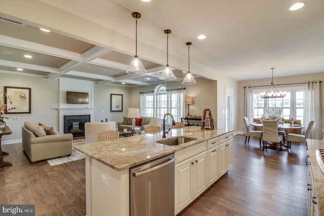 kitchen featuring dishwasher, sink, a center island with sink, and plenty of natural light