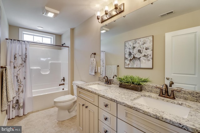 full bathroom with vanity, toilet, shower / bath combo with shower curtain, and tile patterned flooring