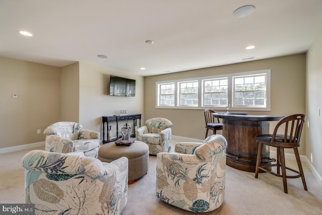 living room with light carpet and bar area