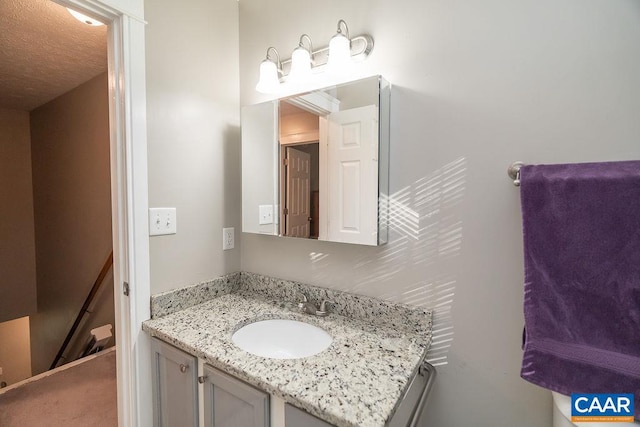 bathroom featuring vanity and a textured ceiling