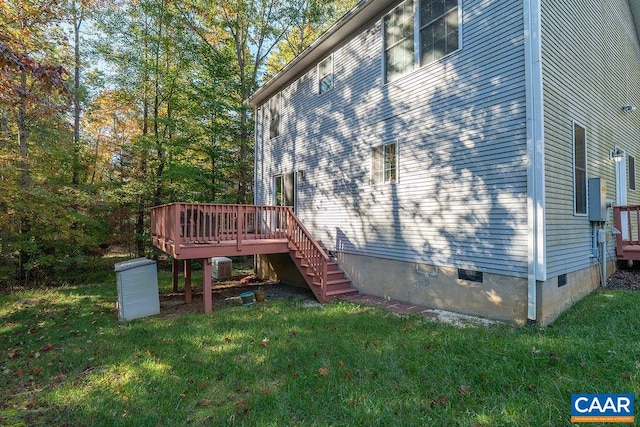 view of property exterior with central air condition unit, a deck, and a lawn