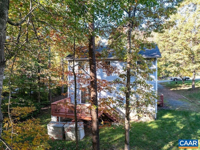 exterior space featuring a deck and a lawn