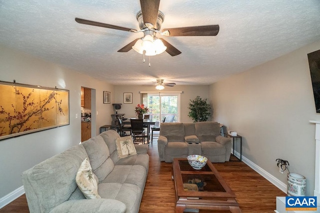 living room with a textured ceiling, hardwood / wood-style flooring, and ceiling fan