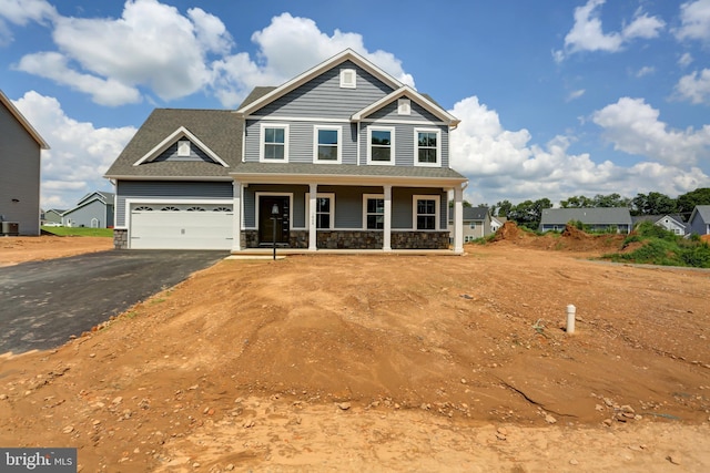 craftsman inspired home featuring a garage and a porch