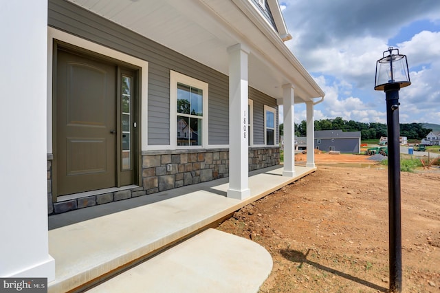 doorway to property featuring covered porch