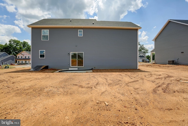 rear view of house with central AC unit